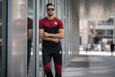 Model in red/black tracksuit - leaning