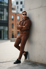 Model leaning casually with arms crossed