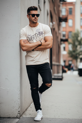 Model leaning with arms crossed